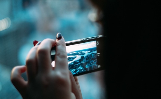 woman-taking-a-picture-on-mobile-phone woman-taking-a-picture-on-mobile-phone