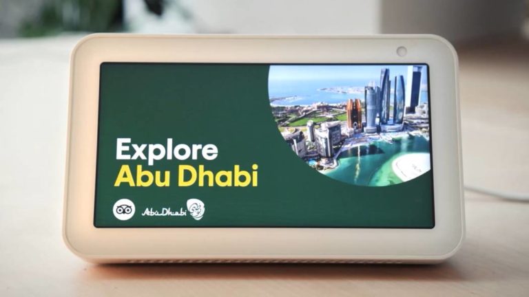 Smart Speaker screen with the voice-activated marketing message 'Explore Abu Dhabi'